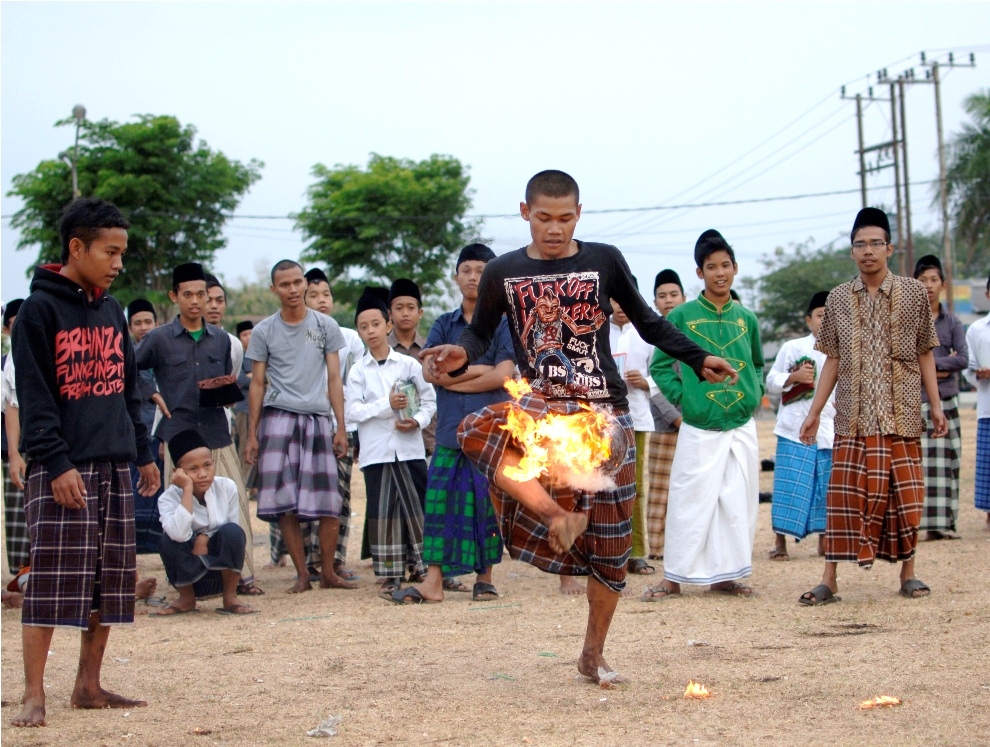 ***EXCLUSIVE*** KEDIRI, INDONESIA - OCTOBER 7: Students play Fire Football at the boarding school Lirboyo on October 7, 2012 in Kediri, Indonesia. THE PREMIER League boasts some of the hottest stars in the world – but they’ve got nothing on these fiery